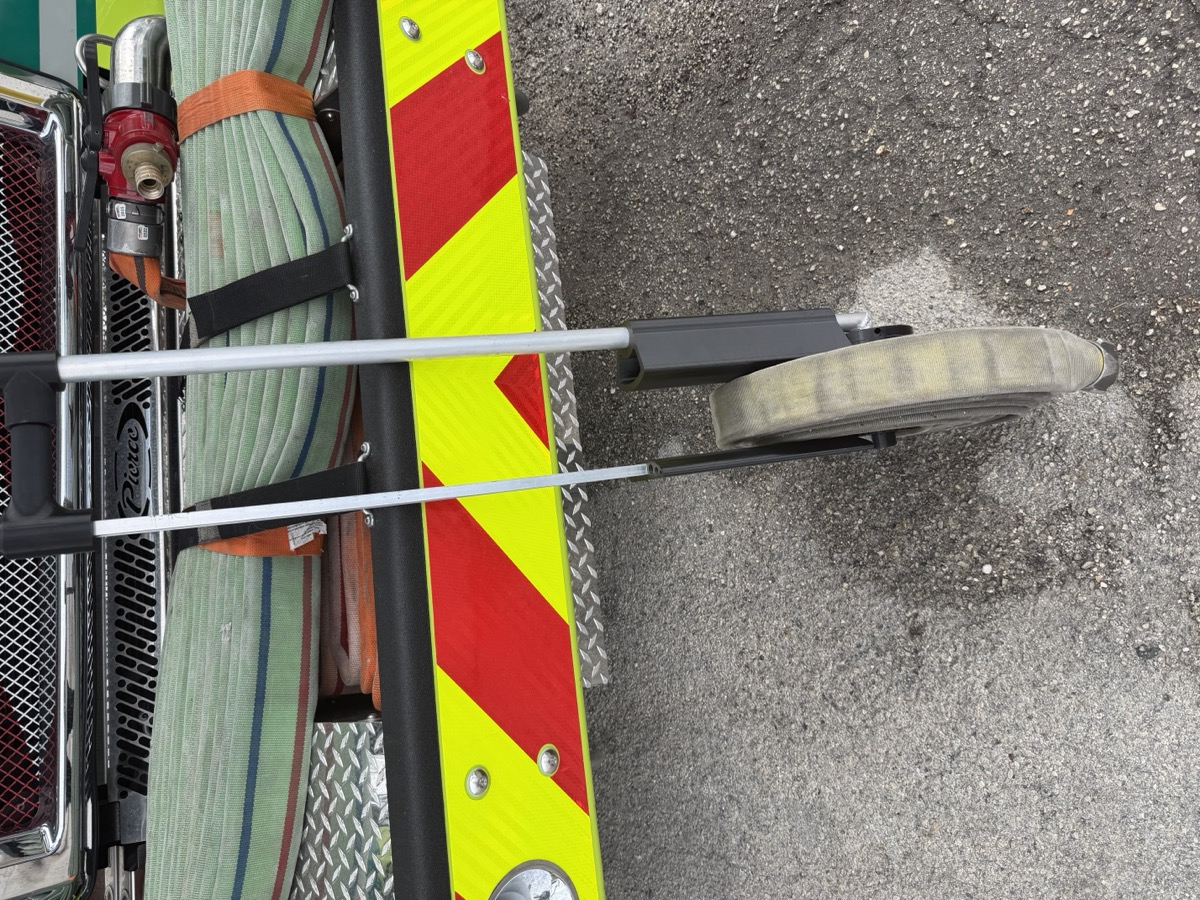 Reelix hose roller in action on fire apparatus